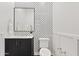 Stylish powder room boasts a modern vanity, decorative mirror, and designer wallpaper at 10134 E Talon Ave, Mesa, AZ 85212