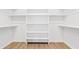 Large walk-in closet with wood-look floors, shelving, and two clothing rods at 10134 E Talon Ave, Mesa, AZ 85212