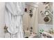 Cozy bathroom featuring a bathtub and shower combo, and decorative shelving at 10320 W Luke Ave, Glendale, AZ 85307
