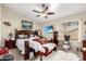 Spacious bedroom with a ceiling fan, large window, and carpeted floor at 10320 W Luke Ave, Glendale, AZ 85307