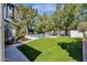 Spacious backyard with a sparkling pool, lush artificial turf, and privacy landscaping at 10360 N 98Th St, Scottsdale, AZ 85258
