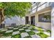 Backyard with a checkered turf, access to the house, and an air conditioning unit at 10360 N 98Th St, Scottsdale, AZ 85258