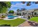 Gorgeous backyard with a pool, spa, lush artificial grass, a built in kitchen and a covered patio at 10360 N 98Th St, Scottsdale, AZ 85258