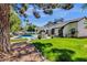 Beautiful backyard with a covered patio, outdoor kitchen, pool, and well-manicured landscaping at 10360 N 98Th St, Scottsdale, AZ 85258