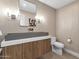 Modern powder room with a sleek countertop sink and elegant light fixtures, offering a chic design at 10360 N 98Th St, Scottsdale, AZ 85258