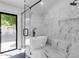 Luxury bathroom with free-standing tub, glass shower and marble-style wall tiles at 10360 N 98Th St, Scottsdale, AZ 85258