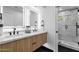 Bright bathroom with dual vanities and shower behind glass doors at 10360 N 98Th St, Scottsdale, AZ 85258