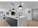 Spacious kitchen featuring a waterfall island, pendant lighting, and stainless steel appliances at 10360 N 98Th St, Scottsdale, AZ 85258