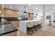 Contemporary kitchen with dark countertops, modern appliances, and a large center island with seating at 10360 N 98Th St, Scottsdale, AZ 85258