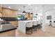 Bright kitchen boasts a large island with seating, modern light fixtures, and sleek countertops at 10360 N 98Th St, Scottsdale, AZ 85258