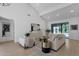 Bright living room with high ceilings, neutral decor, and sliding glass doors to the pool at 10360 N 98Th St, Scottsdale, AZ 85258