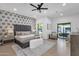 Stylish bedroom with designer wallpaper, ceiling fan and sliding doors leading to the back yard at 10360 N 98Th St, Scottsdale, AZ 85258