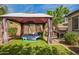 Backyard featuring an artificial lawn, mature trees, gazebo with a trampoline, and grill at 10452 E Natal Ave, Mesa, AZ 85209