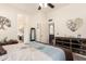 Spacious bedroom with decorative elements and mirrors plus an adjoining bathroom and living room at 10452 E Natal Ave, Mesa, AZ 85209