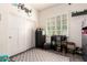 Bedroom with closet, modern shuttered windows, neutral paint, and wood-look tile flooring at 10452 E Natal Ave, Mesa, AZ 85209