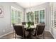 Bright dining room featuring large windows, modern chandelier, and neutral paint at 10452 E Natal Ave, Mesa, AZ 85209