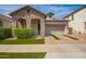 Charming stone accented home featuring a 2 car garage and manicured lawn at 10452 E Natal Ave, Mesa, AZ 85209