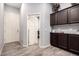 Stylish foyer featuring tile floors, storage cabinets, and neutral paint at 10452 E Natal Ave, Mesa, AZ 85209