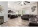 Open concept living room featuring tile floors, neutral paint, and fan at 10452 E Natal Ave, Mesa, AZ 85209