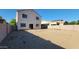 Backyard view of the two-story home with a patio, and gravel landscaping, offering a private outdoor space at 10521 W Toronto Way, Tolleson, AZ 85353