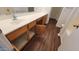 Bathroom vanity with wood cabinets, white countertop, and a view of the flooring at 10521 W Toronto Way, Tolleson, AZ 85353