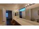 Bathroom with long vanity, large mirrors, and great lighting, offering a bright space at 10521 W Toronto Way, Tolleson, AZ 85353