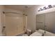 Clean bathroom with a shower-tub combo, a neutral vanity, and bright lighting at 10521 W Toronto Way, Tolleson, AZ 85353