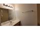 Well-lit bathroom featuring neutral vanity and modern fixtures next to a shower-tub combo at 10521 W Toronto Way, Tolleson, AZ 85353