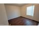 Bedroom with hardwood flooring, a bright window, and neutral walls offering a comfortable space at 10521 W Toronto Way, Tolleson, AZ 85353