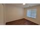 Neutral bedroom featuring laminate flooring and a window with horizontal blinds at 10521 W Toronto Way, Tolleson, AZ 85353