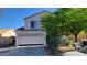 Two-story home featuring a two-car garage, low maintenance landscaping, and a tile roof at 10521 W Toronto Way, Tolleson, AZ 85353