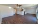 Spacious living area with modern ceiling fan, wood-look laminate floors, and bright, neutral walls at 10521 W Toronto Way, Tolleson, AZ 85353