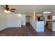 Bright living area featuring a contemporary ceiling fan and an open floor plan with laminate floors at 10521 W Toronto Way, Tolleson, AZ 85353