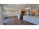 Open-concept layout with wood-look laminate flooring, connecting living room and kitchen at 10521 W Toronto Way, Tolleson, AZ 85353