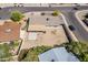 This aerial view shows the home's backyard, large covered patio, and the desert landscaping at 11210 S Bannock St, Phoenix, AZ 85044