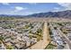 Scenic aerial view of a residential community with desert landscaping and mountain backdrop on a bright, sunny day at 11210 S Bannock St, Phoenix, AZ 85044