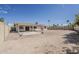 The expansive backyard features a covered patio, privacy fencing, desert landscaping, and mature trees at 11210 S Bannock St, Phoenix, AZ 85044