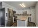 Modern kitchen featuring stainless steel appliances, white cabinets, and butcher block island at 11210 S Bannock St, Phoenix, AZ 85044