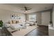 Stylish living room with modern furnishings, a ceiling fan, and contemporary decor at 11210 S Bannock St, Phoenix, AZ 85044