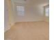 Bright bedroom with neutral carpet and large windows for natural light at 1122 E Meadowbrook Dr, Casa Grande, AZ 85122
