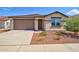 Charming single-story home with a well-manicured front yard and a two-car garage at 1122 E Meadowbrook Dr, Casa Grande, AZ 85122