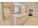 This well-lit kitchen features a large island, quartz countertops, stainless appliances, and sleek gray cabinets at 1122 E Meadowbrook Dr, Casa Grande, AZ 85122