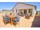 Inviting back patio with a dining table, cushioned chairs, and relaxing lounge area, perfect for outdoor entertaining at 1123 E Meadowbrook Dr, Casa Grande, AZ 85122