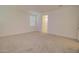 Bright, carpeted bedroom with a window and a doorway leading to an en-suite bathroom with a shower at 1123 E Meadowbrook Dr, Casa Grande, AZ 85122