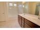 Bathroom featuring a shower-tub combo, double vanity, and neutral-toned tile flooring at 1130 E Atwood Dr, Casa Grande, AZ 85122