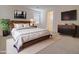 Relaxing main bedroom featuring a decorative headboard, neutral decor, and an ensuite bathroom at 1130 E Atwood Dr, Casa Grande, AZ 85122