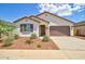 Charming single-story home featuring a two-car garage, neutral stucco, and low-maintenance landscaping at 1142 E Atwood Dr, Casa Grande, AZ 85122