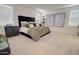 Well-lit bedroom featuring neutral carpet, modern artwork and a large window that allows for lots of natural light at 1142 E Atwood Dr, Casa Grande, AZ 85122