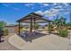 Community picnic area featuring shaded seating and adjacent playground at 1142 E Atwood Dr, Casa Grande, AZ 85122