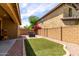 A quaint backyard that is a outdoor sanctuary featuring artificial turf and brick accents at 1202 E Binner Dr, Chandler, AZ 85225
